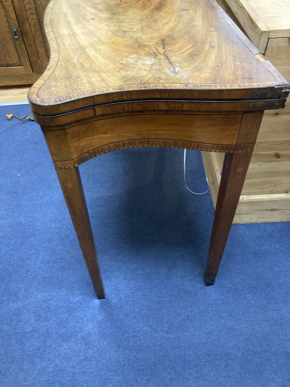 A George III mahogany and satinwood serpentine card table, width 88cm depth 44cm height 76cm